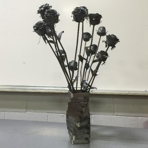 Bouquet of metal roses and vase, created by R.G. Drage CTC Metal Fabrication students.