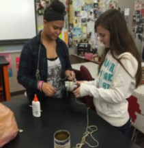 Students working on building toys out of items that normally would be thrown away.