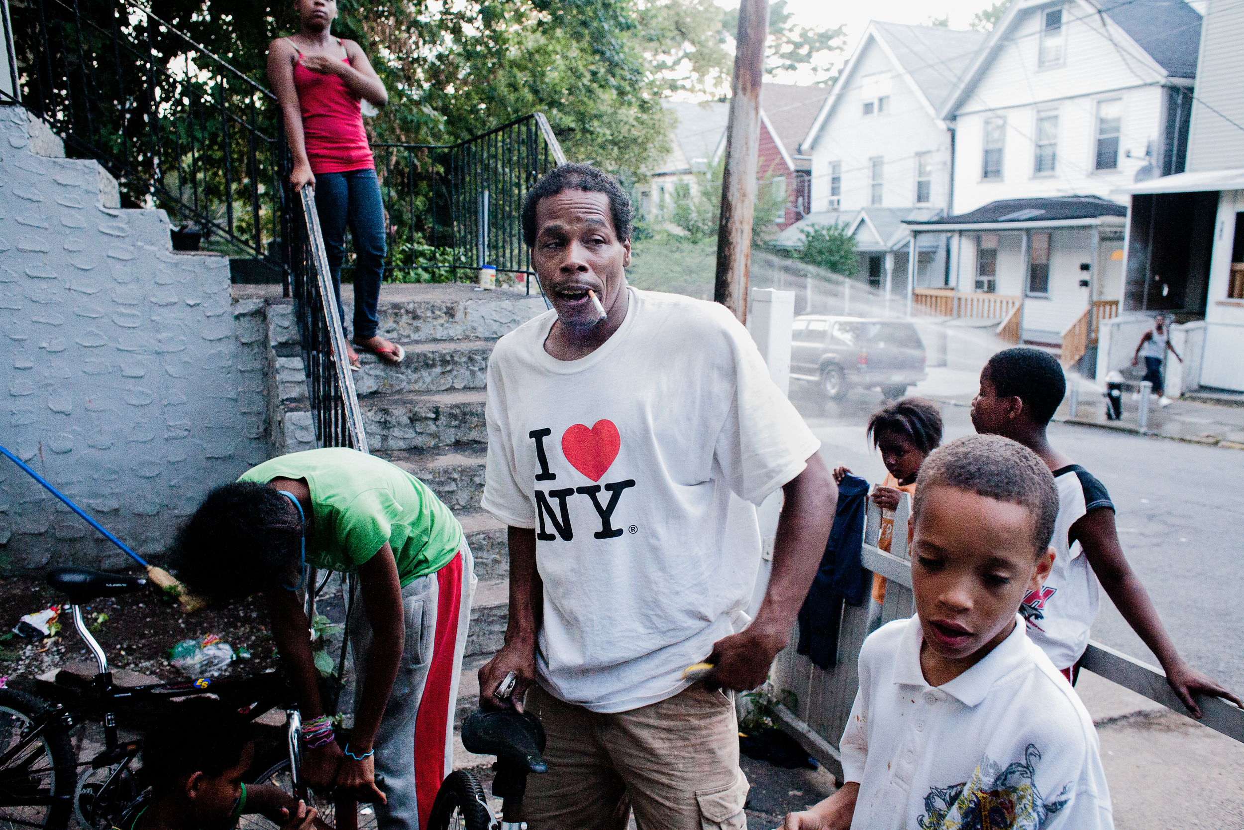 A man fixes bikes on Roberta's block in Staten Island, 2010.