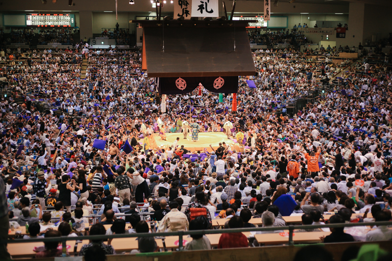 I grabbed my camera quickly to snap this photograph. This was taken at the end of the last bout with whom Zac and I called "The People's Champ" contended and won in a few seconds. After he won everyone roared and starting throwing their purple cushions towards the center of the arena. So many traditions and rituals Zac and I still fail to understand...