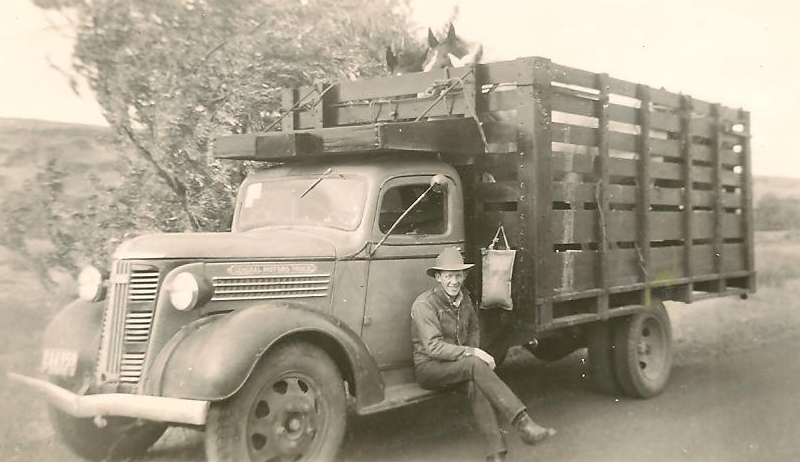Red Anderson resting on an original gooseneck equipped with a water bag.