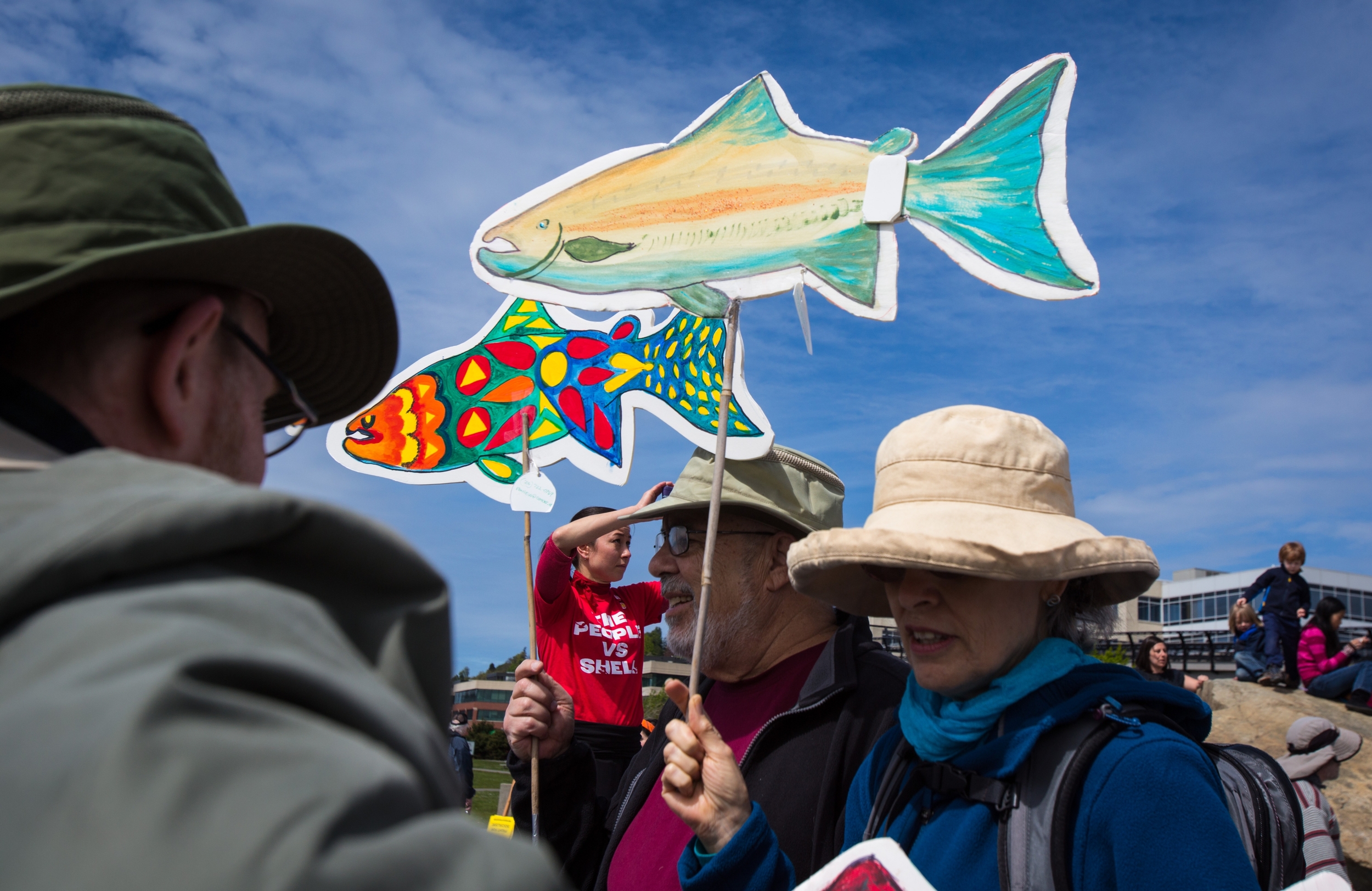   Protesters hold up paper fish during a protest against the planned arrival of Shell's oil drilling rig at Myrtle Edwards Park on Sunday, April 26, 2015. Hundreds gathered for the "Shell No: Seattle Draws the Line" protest organized by various organ