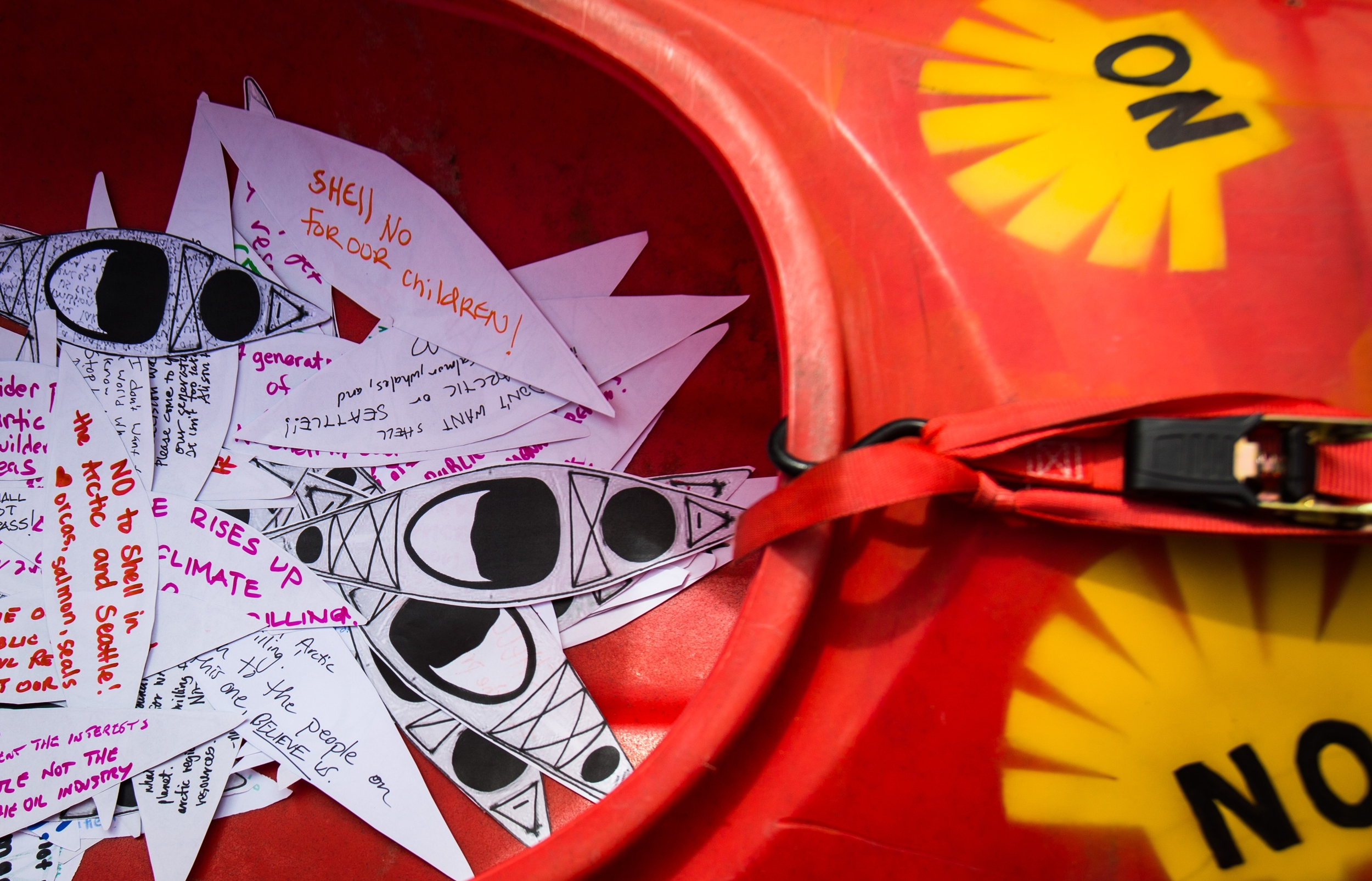  Paper Kayaks with notes protesting the planned arrival of Shell's oil drilling rig pile up in a kayak waiting to be transported to the Port of Seattle during a protest at Myrtle Edwards Park on Sunday, April 26, 2015. Hundreds gathered for the "She
