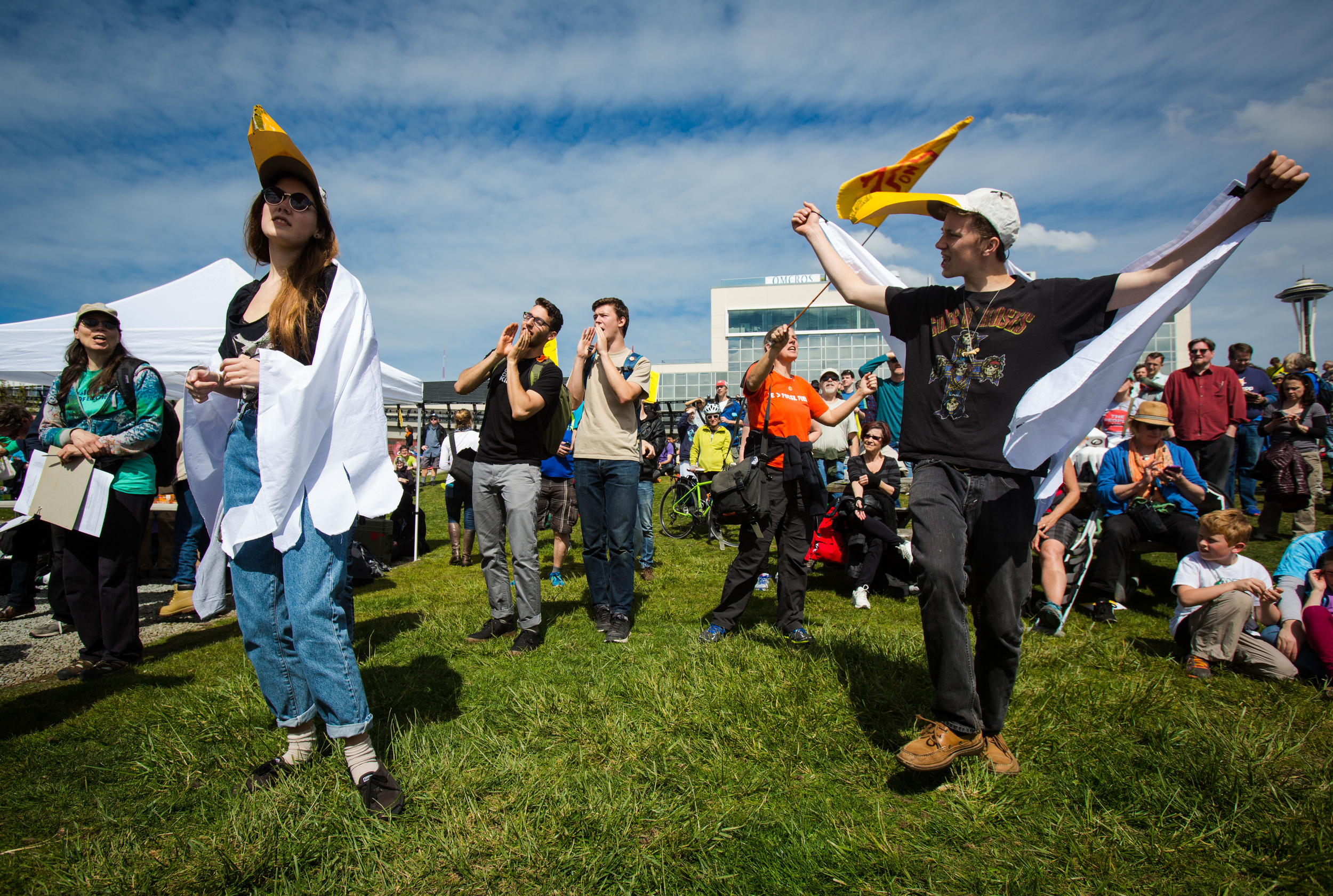  Reve Hansen and Whealon Costello dance in seagull hats and capes in protest against the planned arrival of Shell's oil drilling rig at Myrtle Edwards Park on Sunday, April 26, 2015. Hundreds gathered for the "Shell No: Seattle Draws the Line" prote