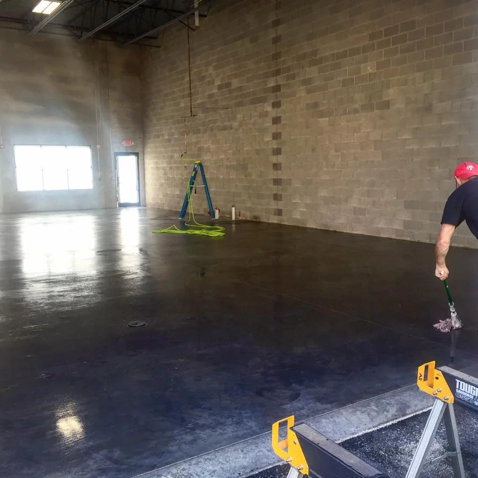 Prepping and sealing the new concrete floor.
