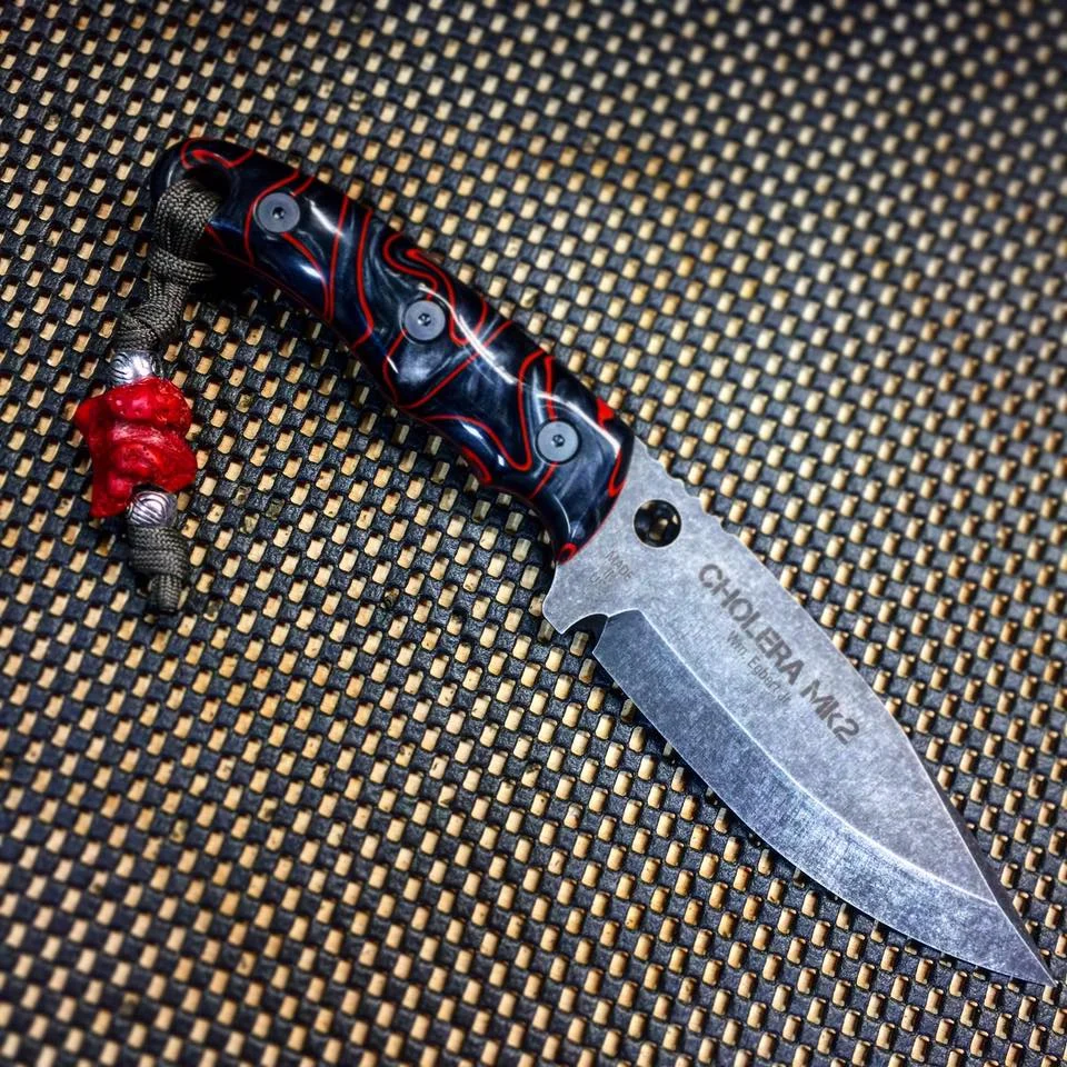 The Cholera Mk2 in black wash finish, Kirinite lava grips and a red bone bead.
