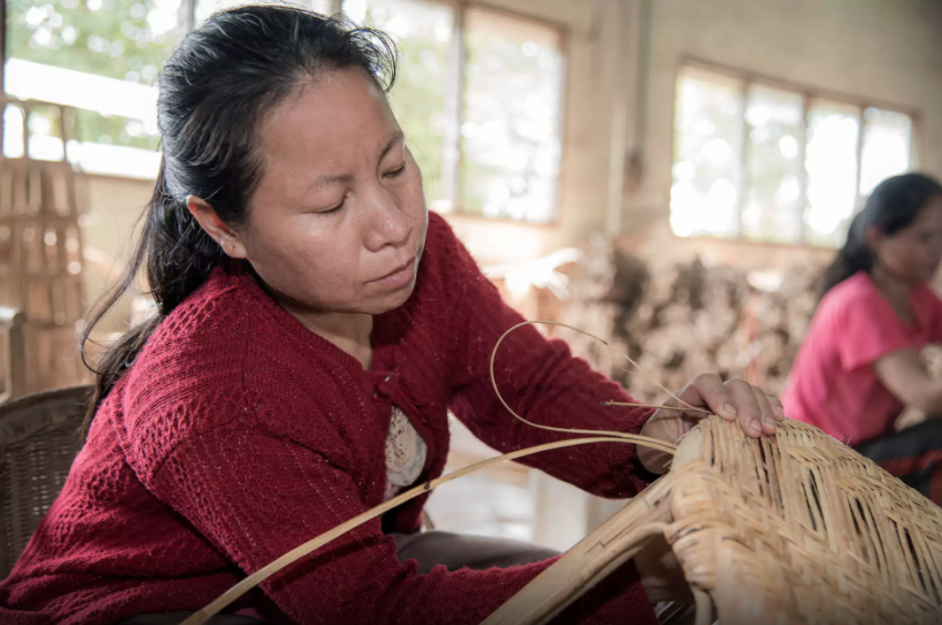 Seng Urdakham, 40, weaves rattan chairs and products at the Danlao Factory in Vientiane, Laos. Photo by ©Thippakone Thammavongsa / WWF-Laos via wwf.exposure.co
