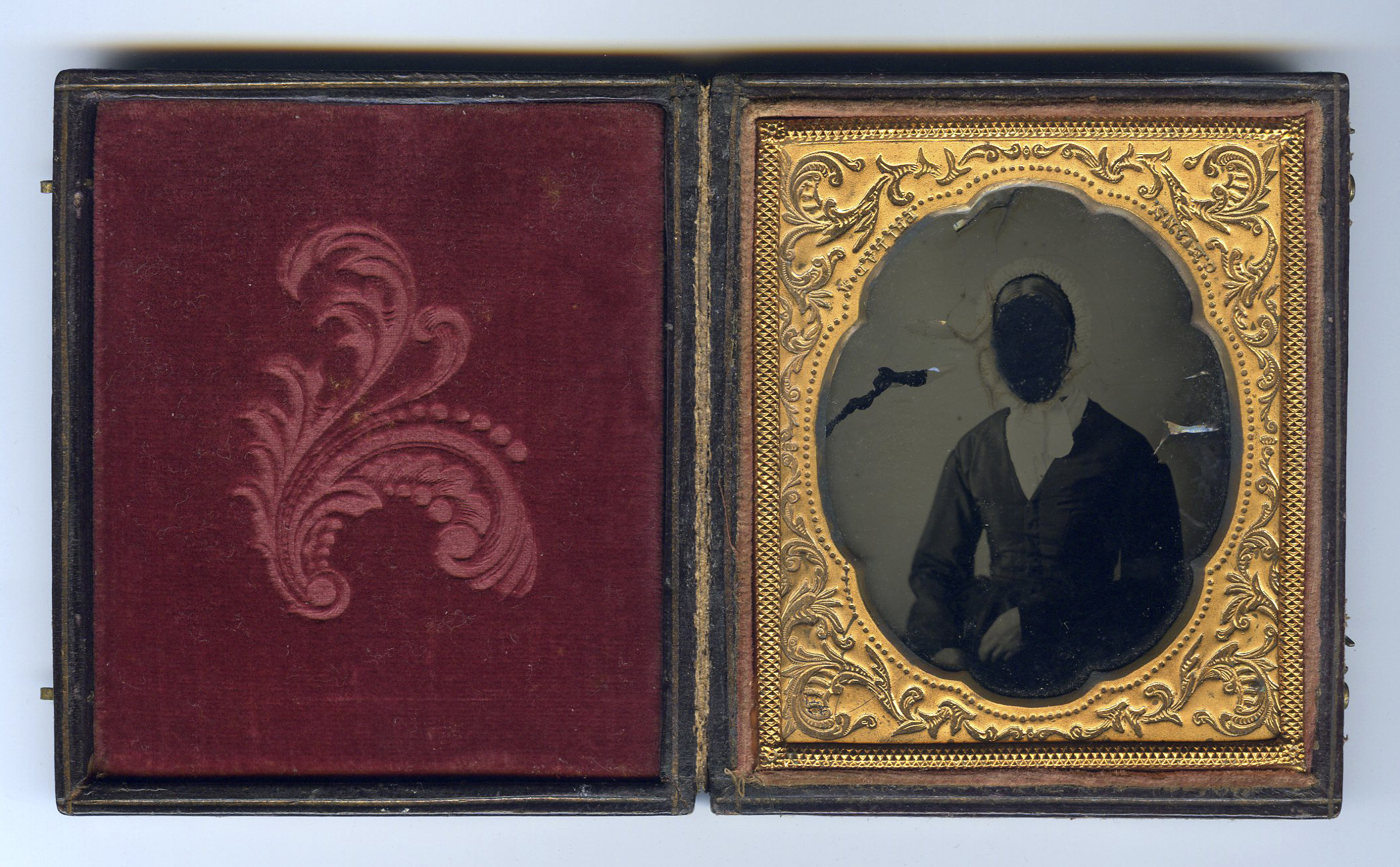 Antique ambrotype, found in an antique store. Photographer unknown. Person who obliterated the identity of the subject likewise unknown... but rather interesting to speculate about.