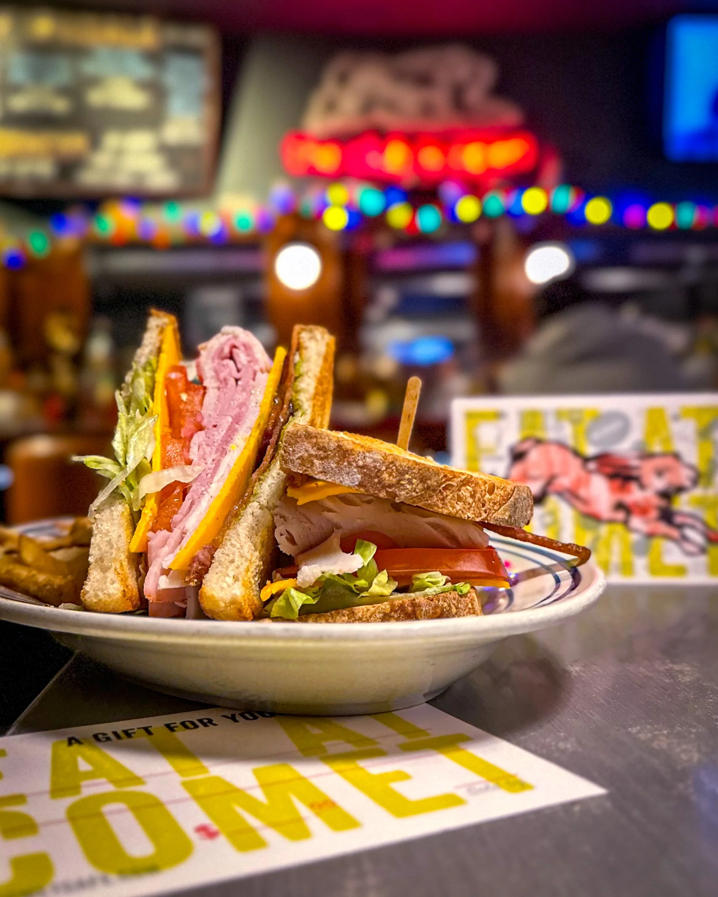 Comet Cafe club surrounded by Comet gift cards.