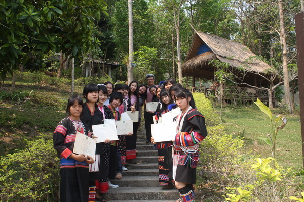 Students in traditional dress receiving their cerificates