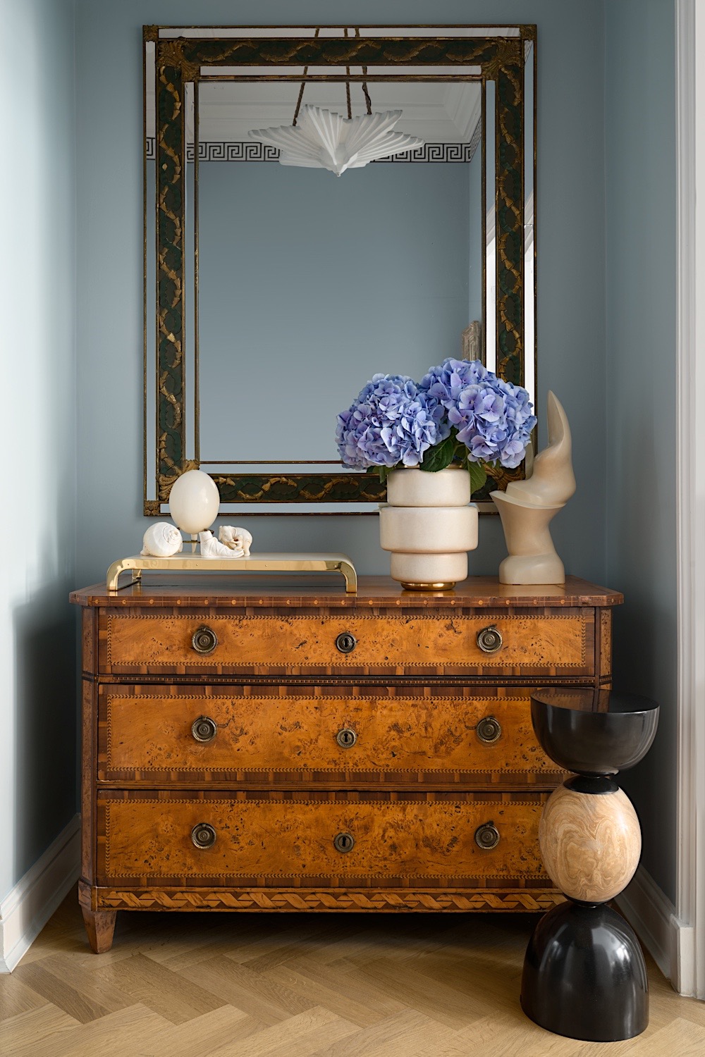  Antique Swedish commode, Vintage 1940’s mirror, vintage plaster hanging fixture, parchment tray &amp; vase and bronze &amp; stone table all by Alexander Lamont.&nbsp; 