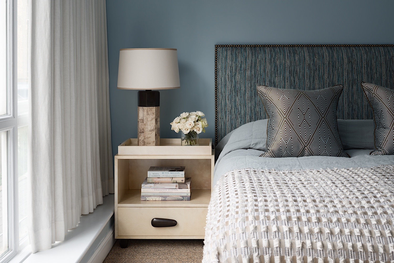  Bespoke headboard in a Toyine Sellers material, bronze &amp; shagreen table lamp and parchment &amp; bronze bedside table by Alexander Lamont. Hand woven silk cushions by Oro. 