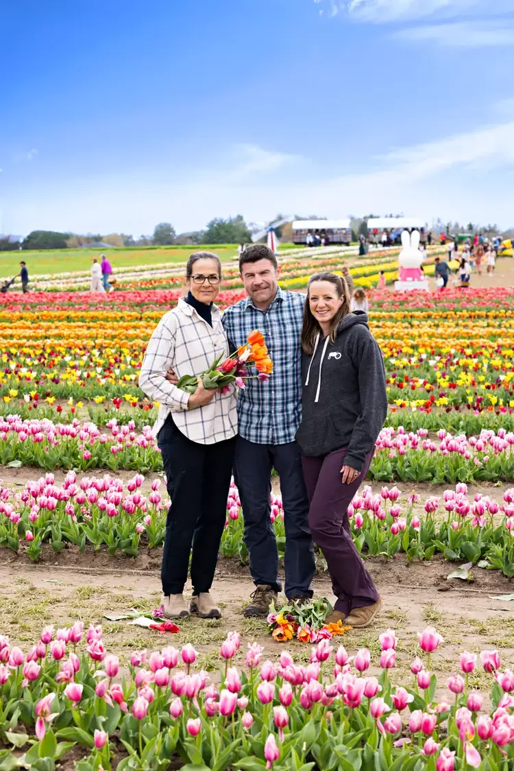 Leslie, Michael, and Jess Dawley standing in their tulip fields in 2025