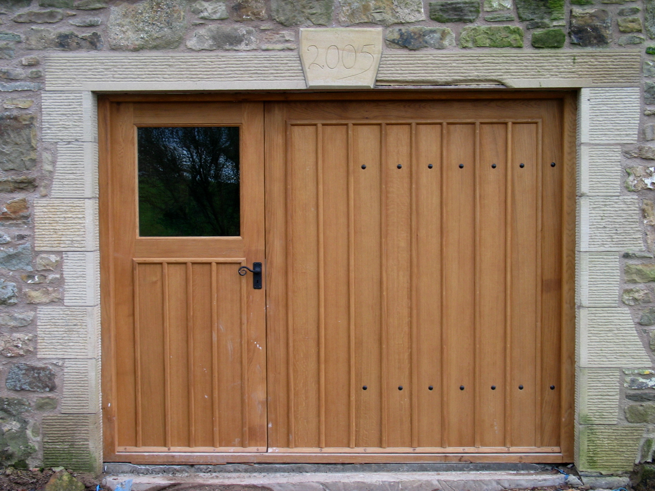 Great way to take care of the hole left when you remove a garage door from a stone house.