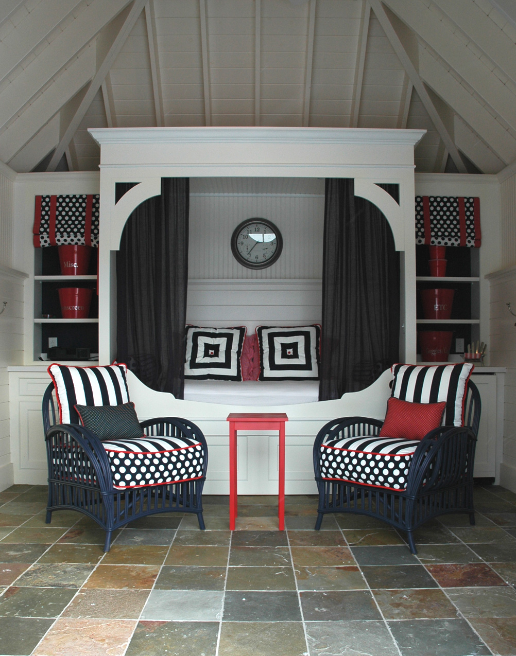 Another built in daybed. The drawer beneath holds another twin mattress. This is in a pool house. Side cabinetry holds a beverage fridge on one side and games on the other. 