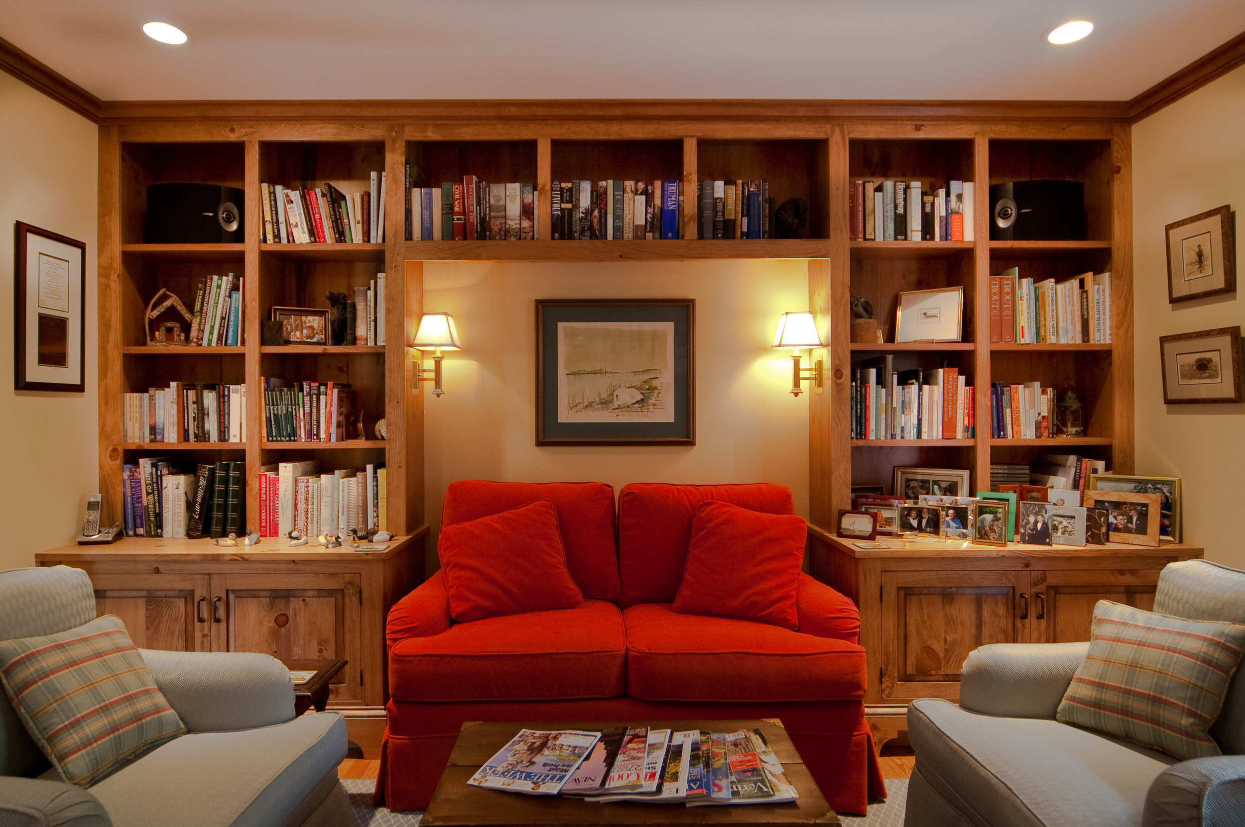 These built ins were constructed with this love seat in mind. Library sconces mounted above the love seat help illuminate the area for reading.
