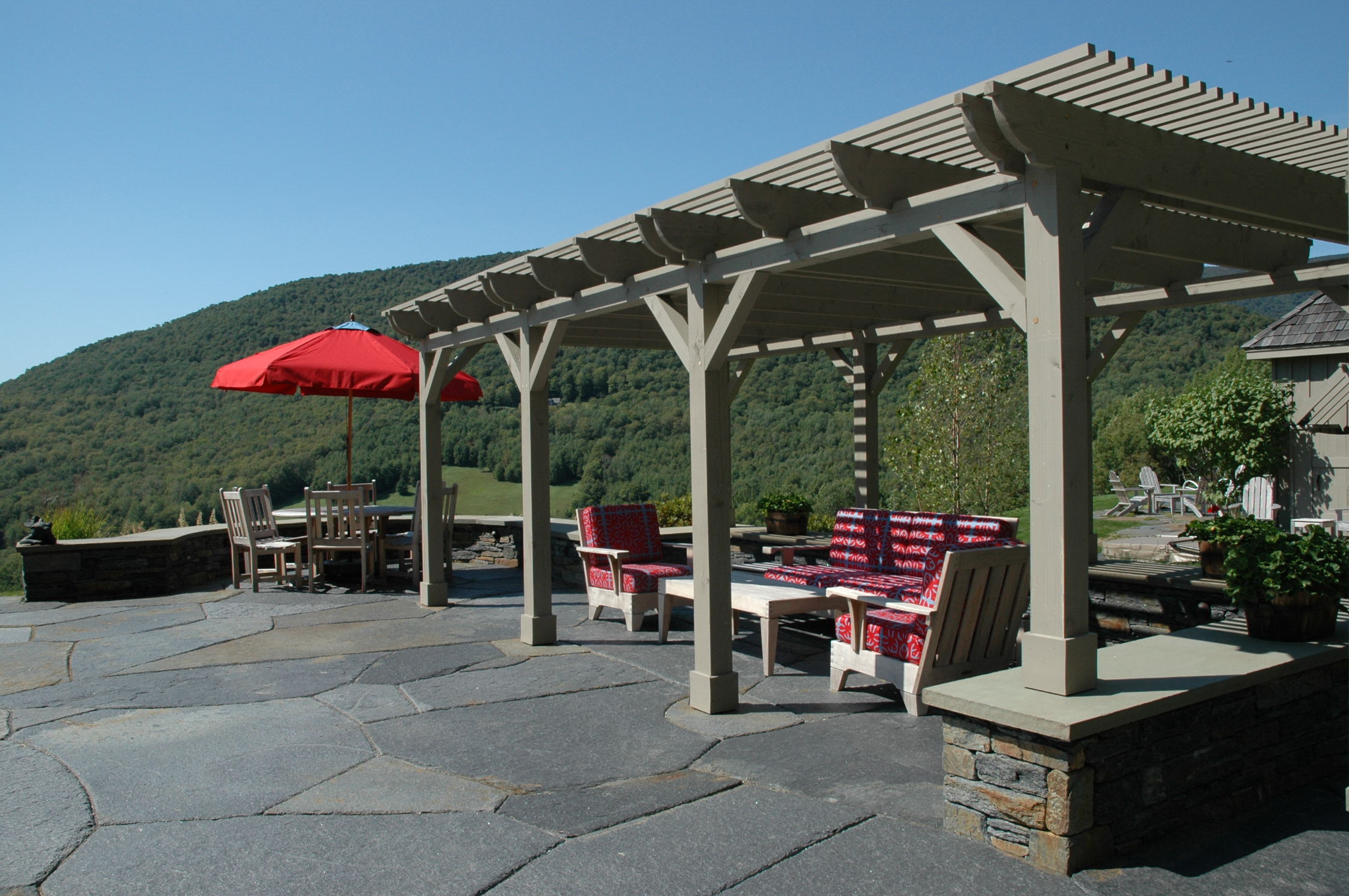 This pergola was designed by Ramsay Gourd Architects using GPS technology to site it to provide shade at the peak times of the day in the summer months. The teak furniture sports Donghia Sunbrella cushions.