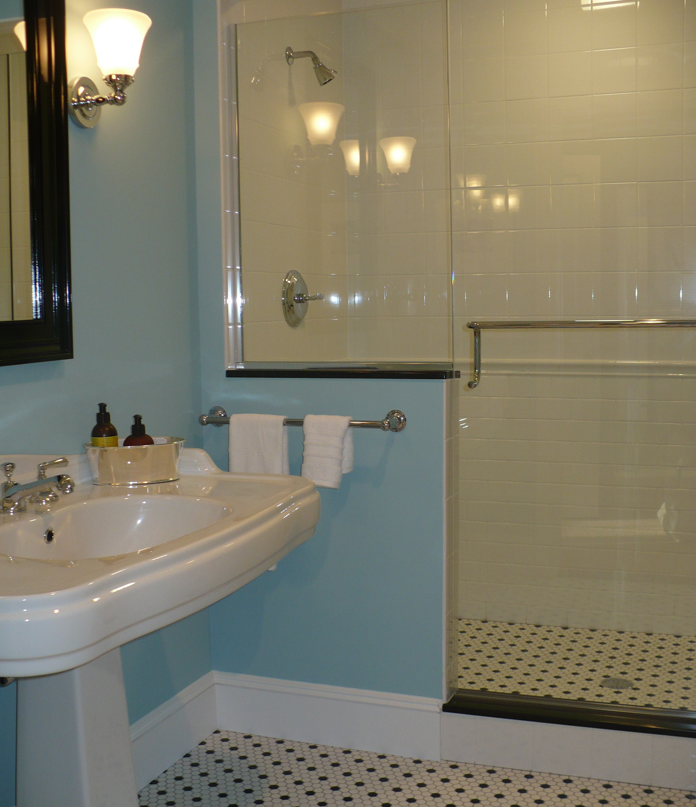 We chose Benjamin Moore Summer Shower for the walls in this new bath. When paired with the white tiled shower and the white with black dot hex tile on the floor, it evokes bathrooms of days gone by. Only this bathroom has all new plumbing! 