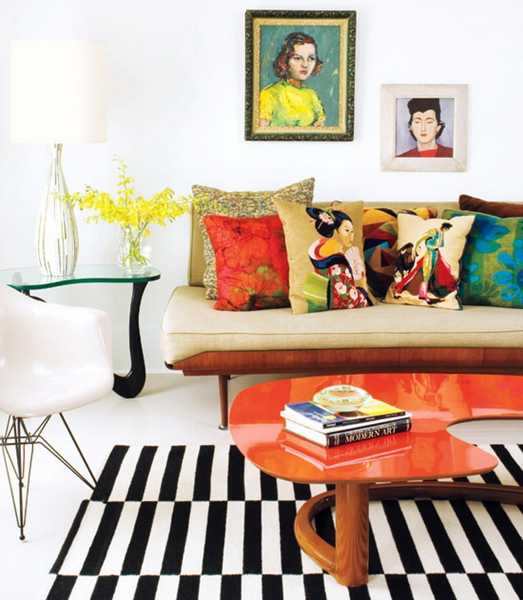 Lacquered orange top on this modern table adds just the right amount of punch to this room.