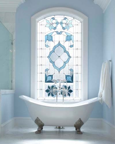 This classic stained glass window transforms this beautiful bathroom without overwhelming the space and compliments the stunning claw foot tub perfectly, highlighting it's vintage qualities.