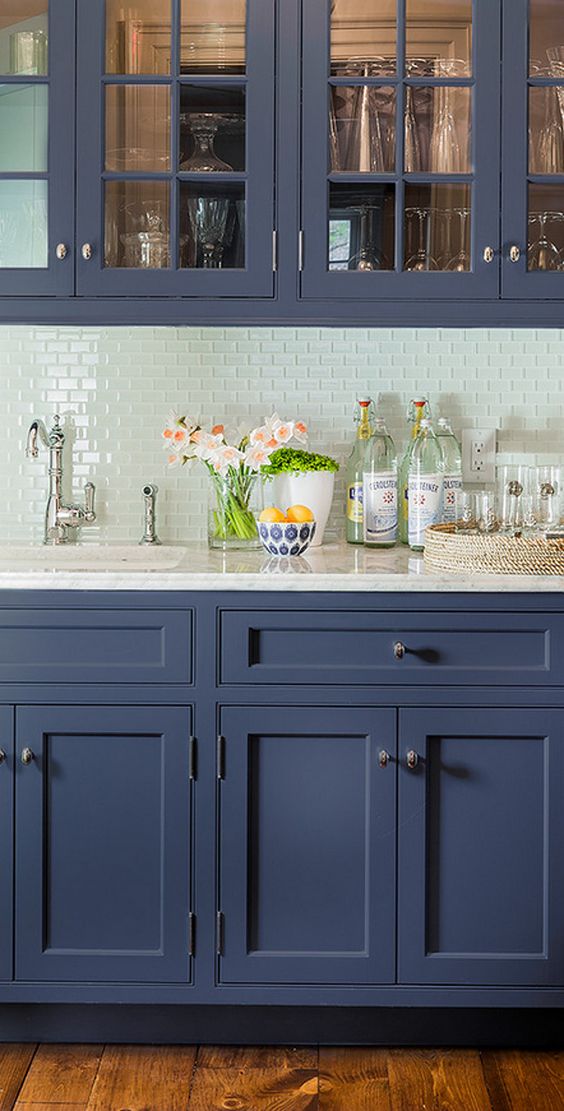 The hint of color in this colored glass backsplash is just enough to lift the space above it's routine, adding depth and visual interest to the space.