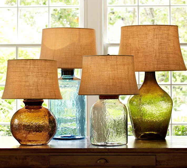 Lighting is an easy yet impactful way to introduce color, and colored glass, into a space. Whether it's table lamps, pendant lighting or a chandelier, they can go from a subtle glow to a brilliant splash of color.