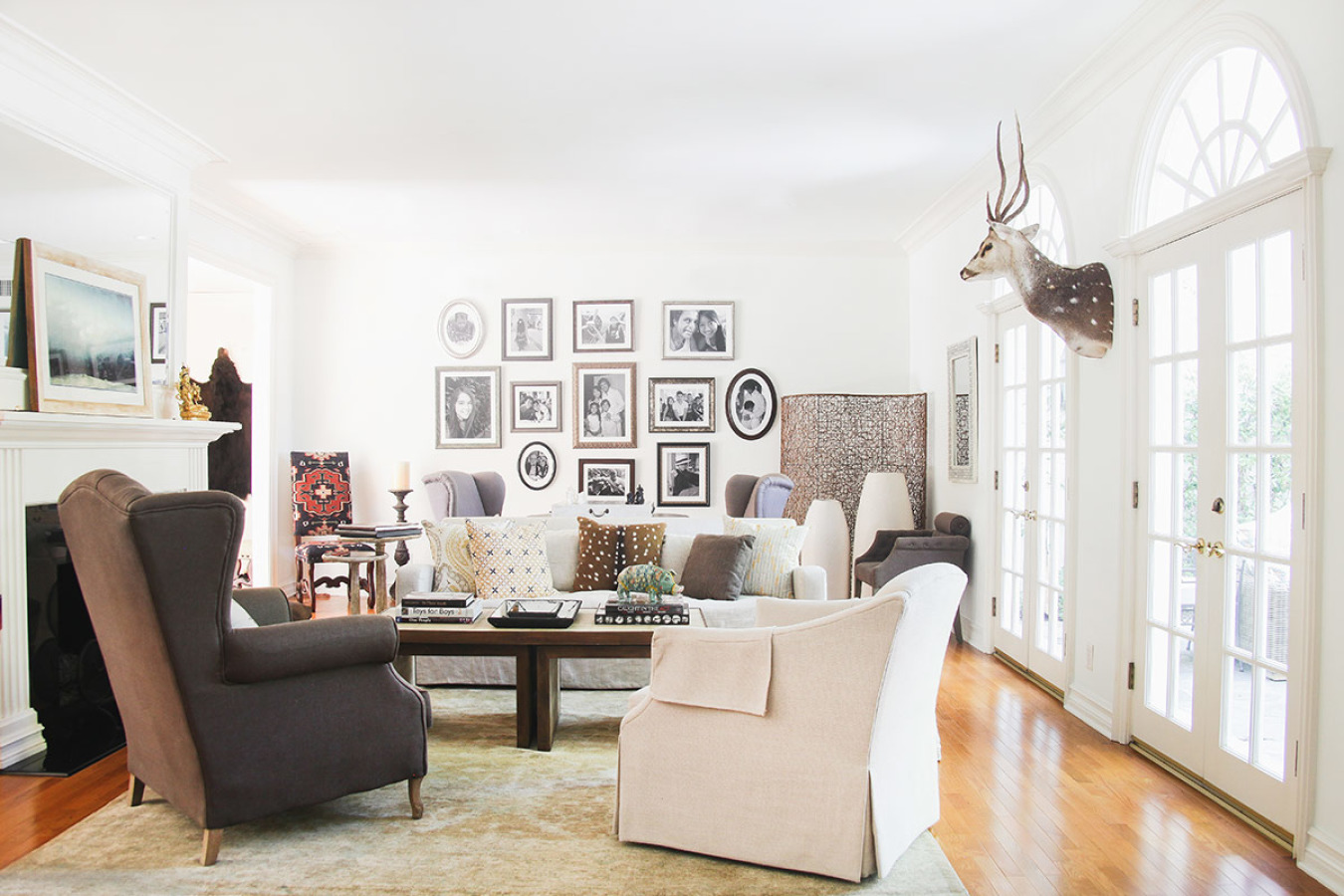 In this cozy room, family photos printed in black-and-white lends an authentic and personal touch that compliments the neutral color palette.