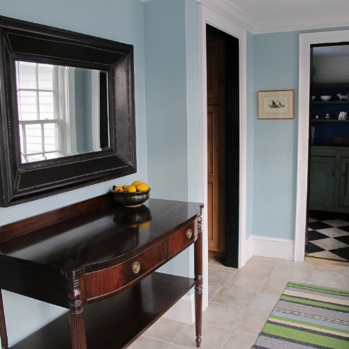 This mirror was artfully placed to not only reflect light, but to bring the outside in! 