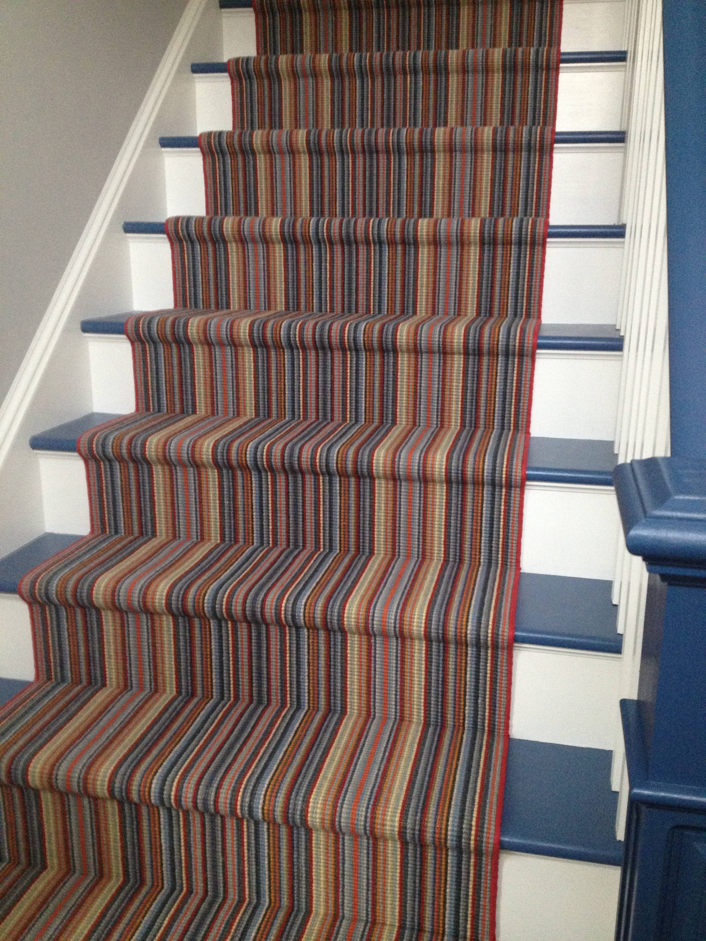 Before the renovation of this house, these wood treads leading to a play room were a hazard for the 3 active boys that vacationed here. By painting the treads and adding this bound runner from Weave Tuft we not only added stability but FUN STRIPES! 