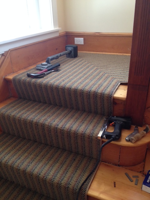 Our installer graciously stepped out of the way for the shot! This Prestige Mills carpet was bound by the installer who also added the mitered corner so the stripe could flow up the stairs. A nice touch in this antique home.