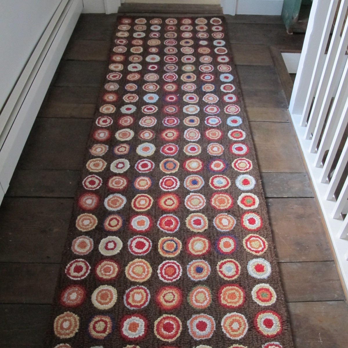 We used this Dash and Albert runner on top of 200 year old floor boards. Without the brightly colored runner the boards screamed to be refinished. But the beautiful runner muted the imperfections in the boards. They work well together.