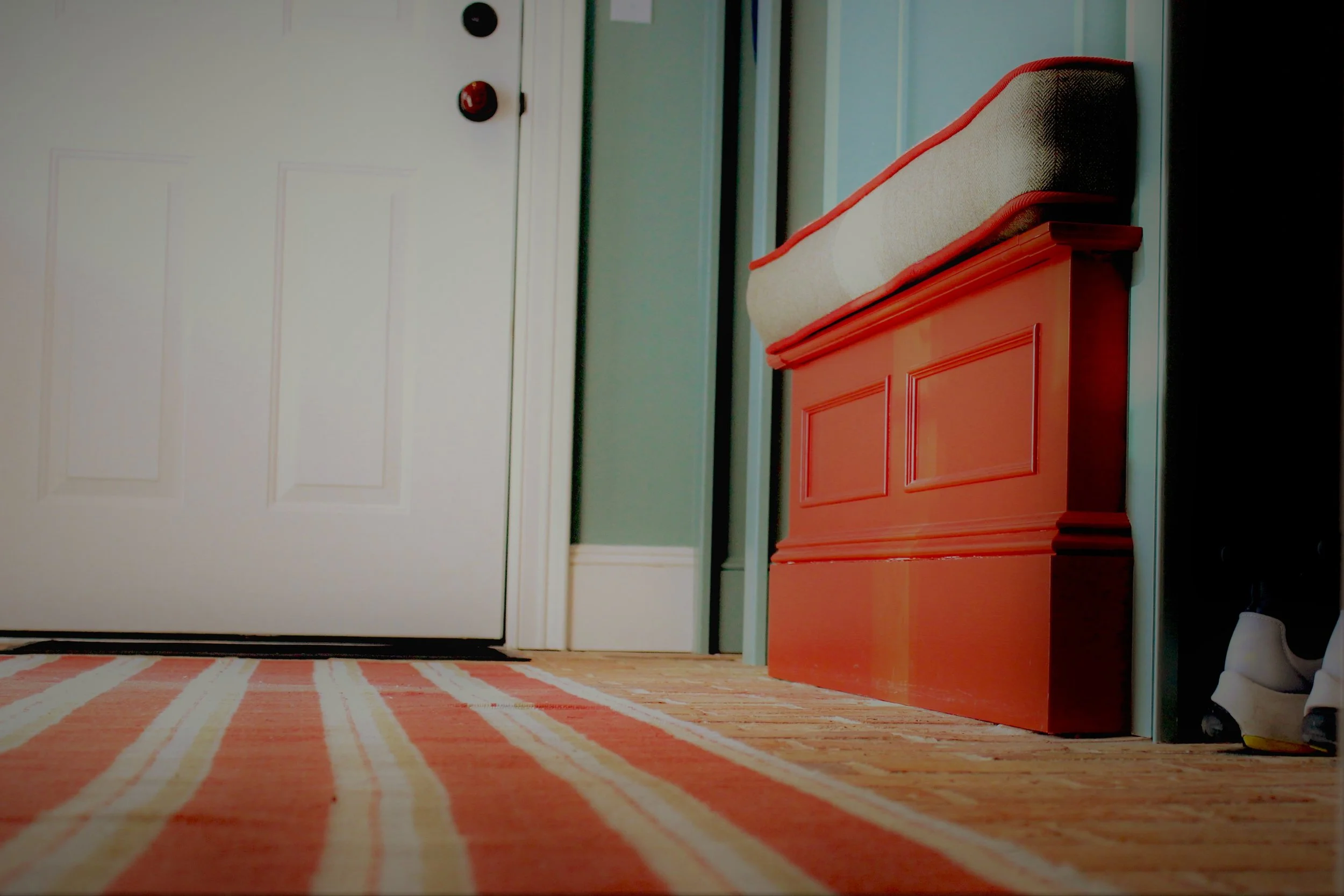 We had the pleasure of working on this home from the ground up. In the mudroom we played with texture and color. The floor is re-purposed brick layered with a woven cotton rug. The built in bench is painted a contrasting color to the walls. We echoed the color in the rug and the cording on the cushion. All the while the wood trim and door are white. This makes a nice frame around the room.