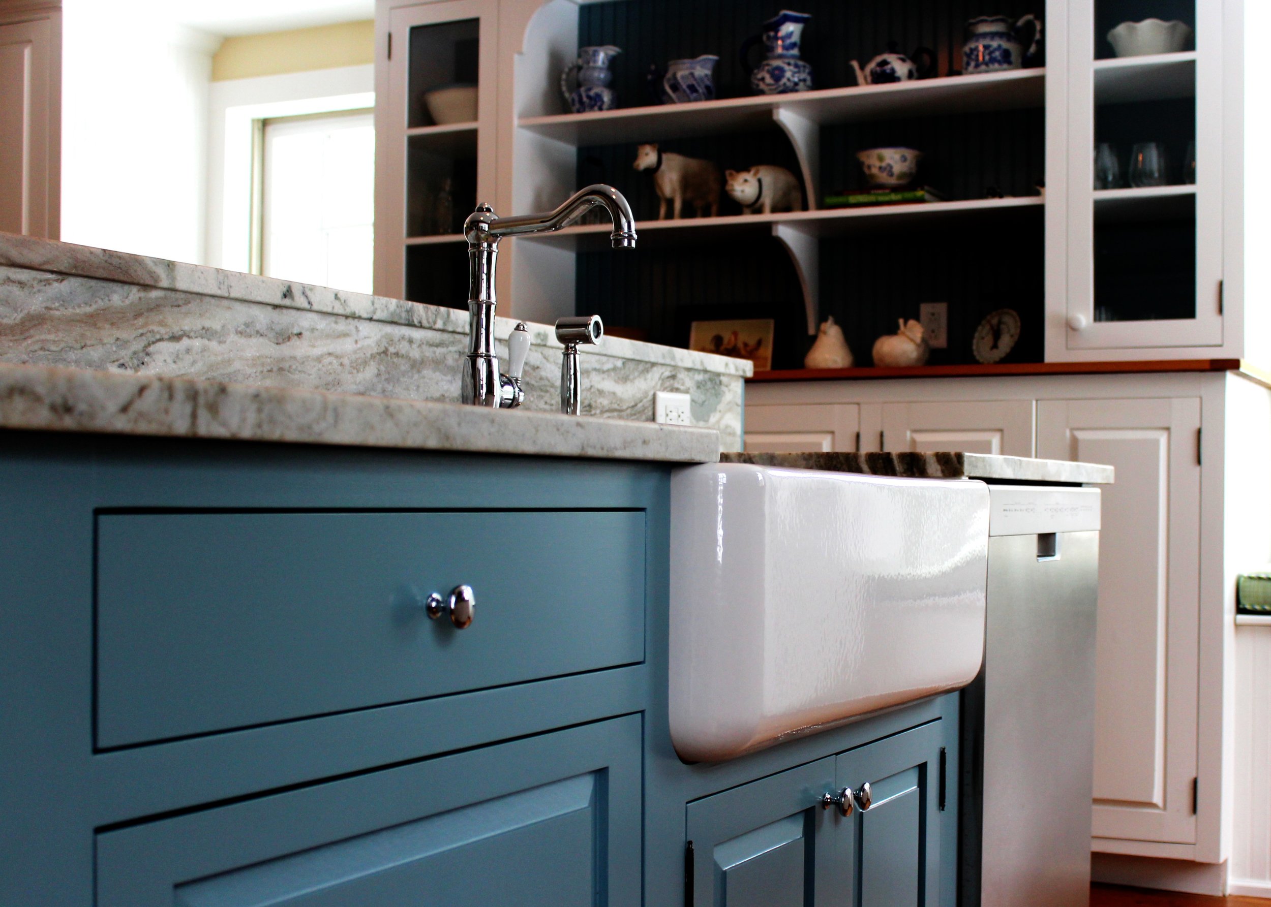This farmhouse sink is in an island with a breakfast bar. Both the island and the breakfast bar have the same stone top. We book matched the slab for the back splash. Not only is it functional, it's beautiful!
