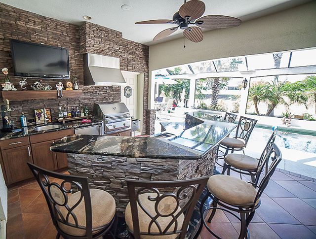 These clients are ready for fall entertaining 🍂 🏈 🔥 -- football on tv, steaks on their (@twineaglesgrills ) grill, fully stocked (custom weatherproof resin kast) cabinets, with fresh cocktails sitting atop the granite bar and friends lined up on b