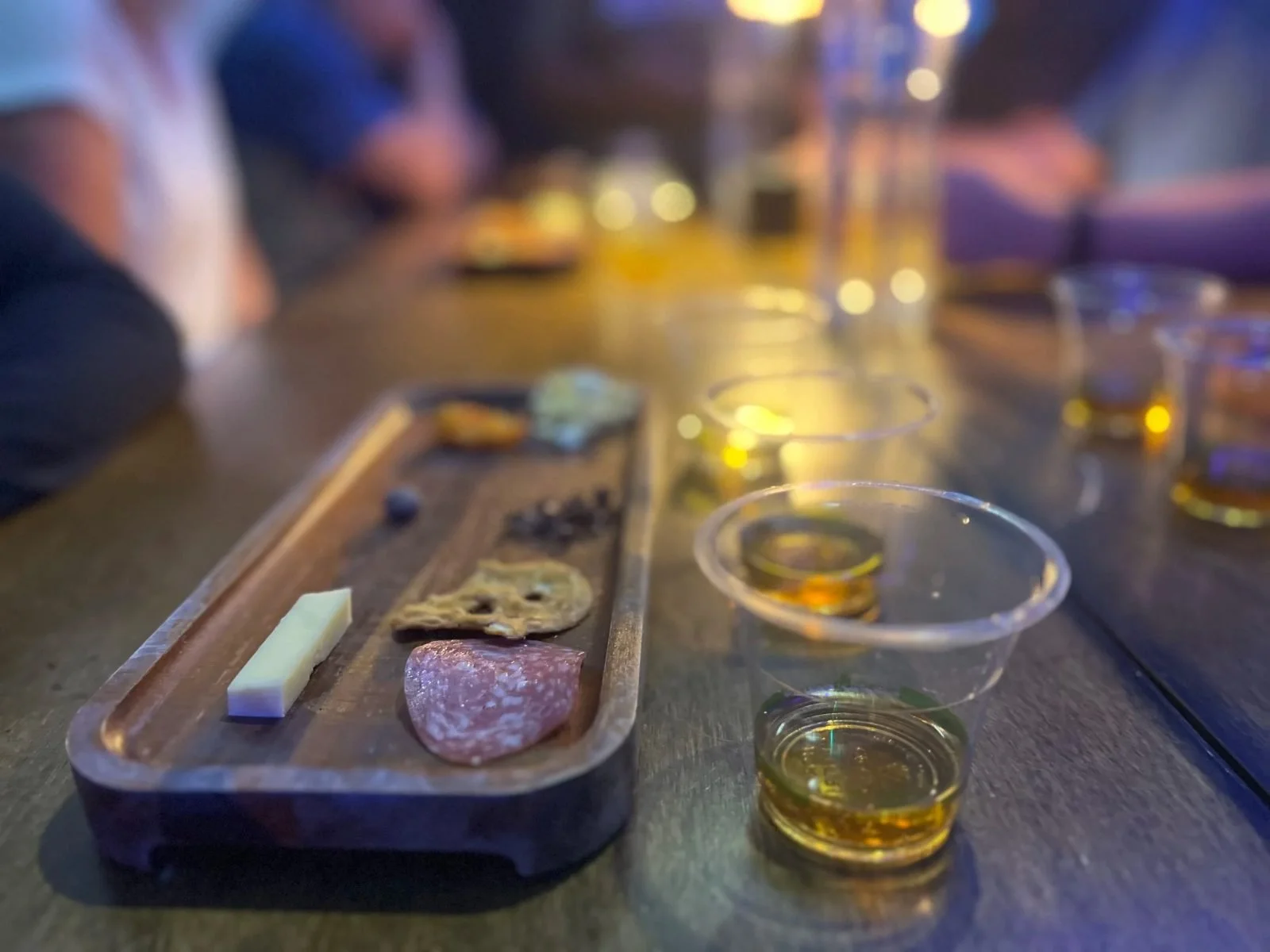 Tasting glasses and snacks on a bar table during a group tour