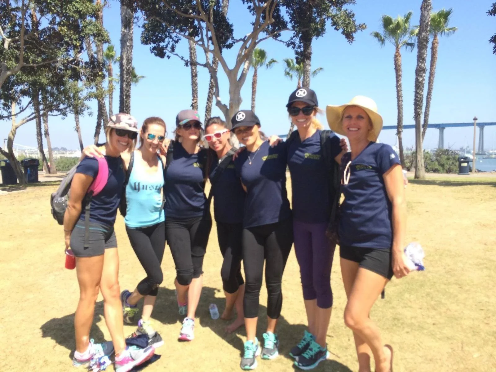 Team posing together in a seaside park after an activity