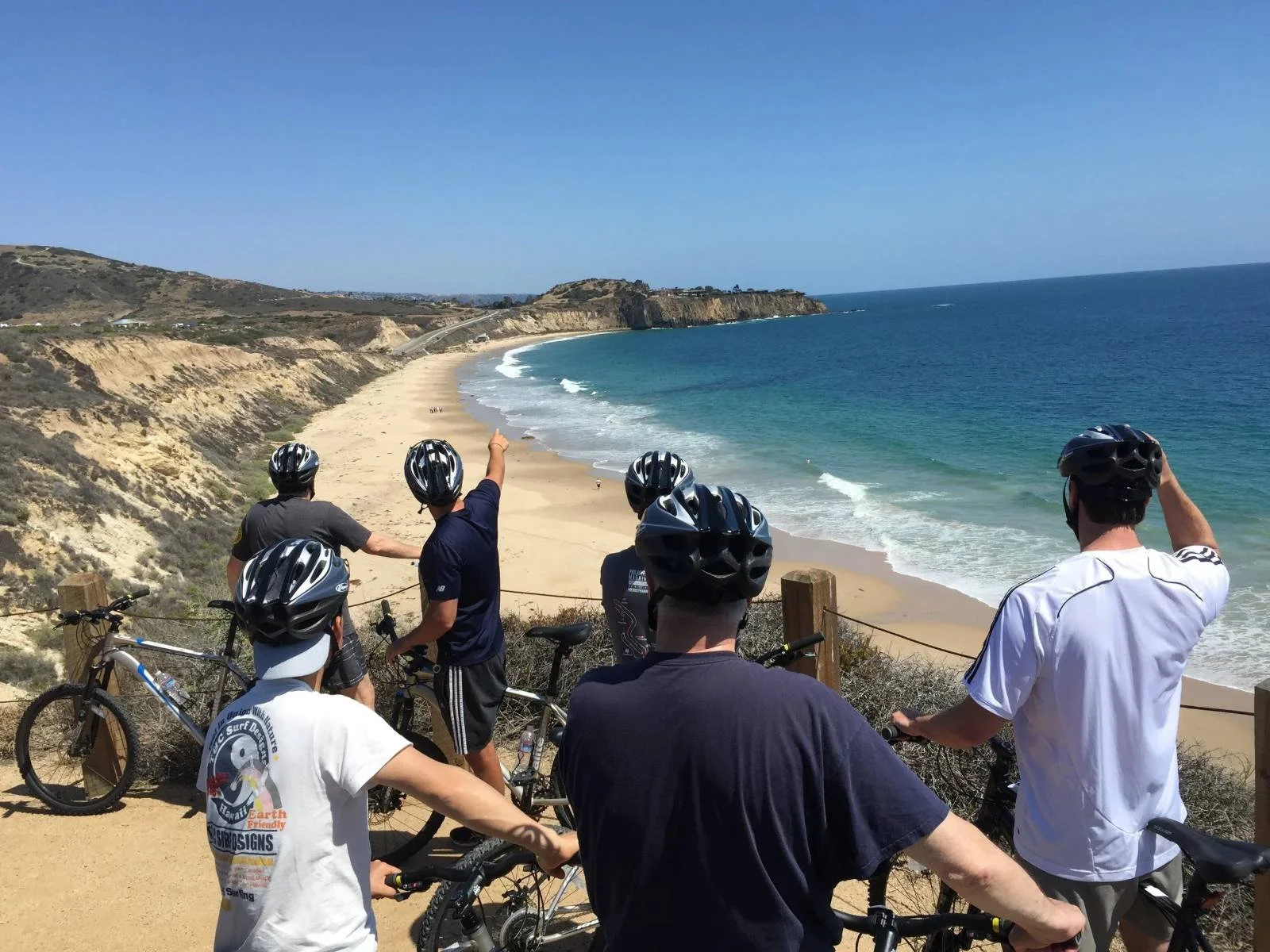 E-bike tour group overlooking a beach and coastline