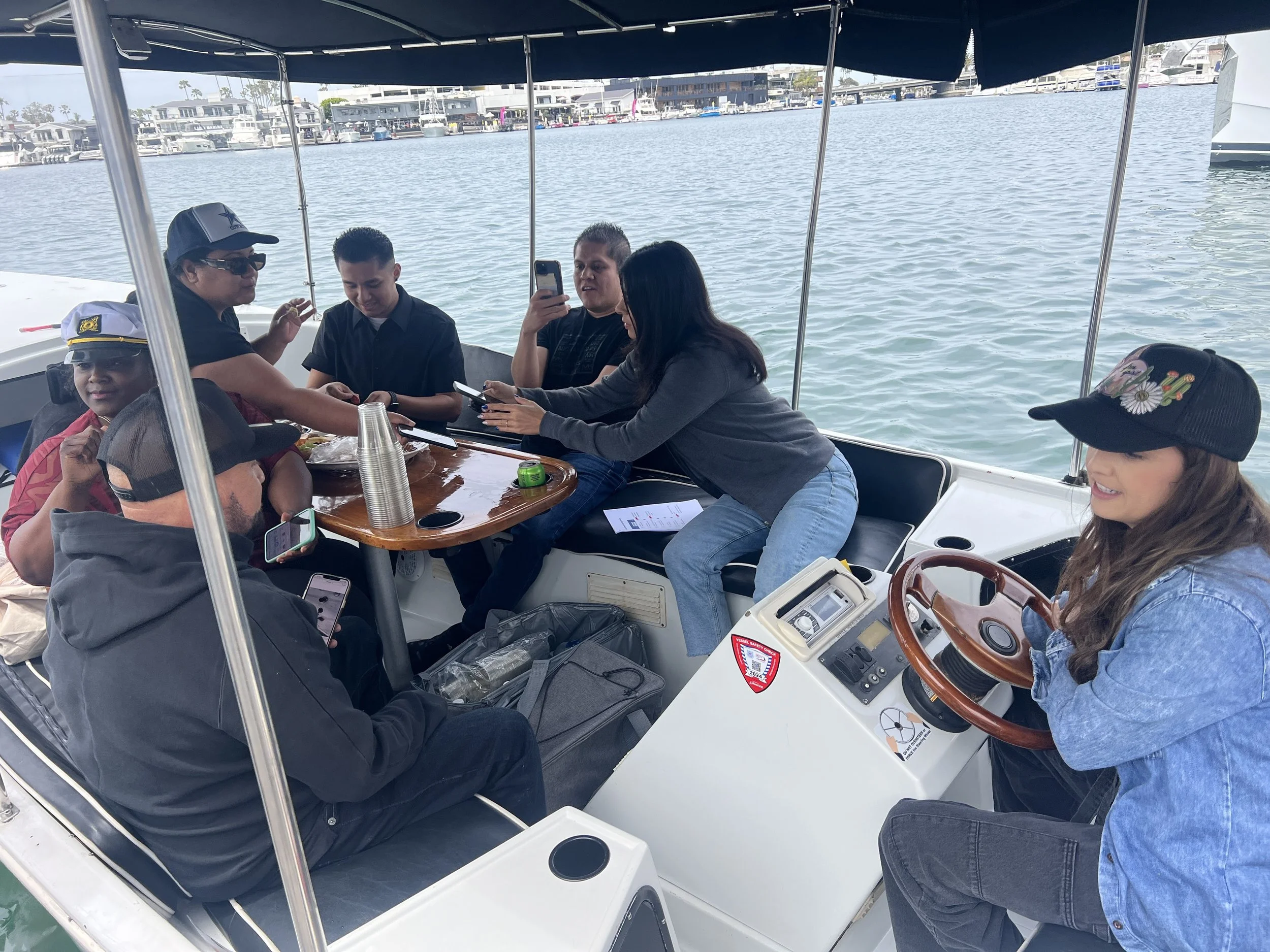 Coworkers chatting and snacking on a Newport Harbor Duffy cruise