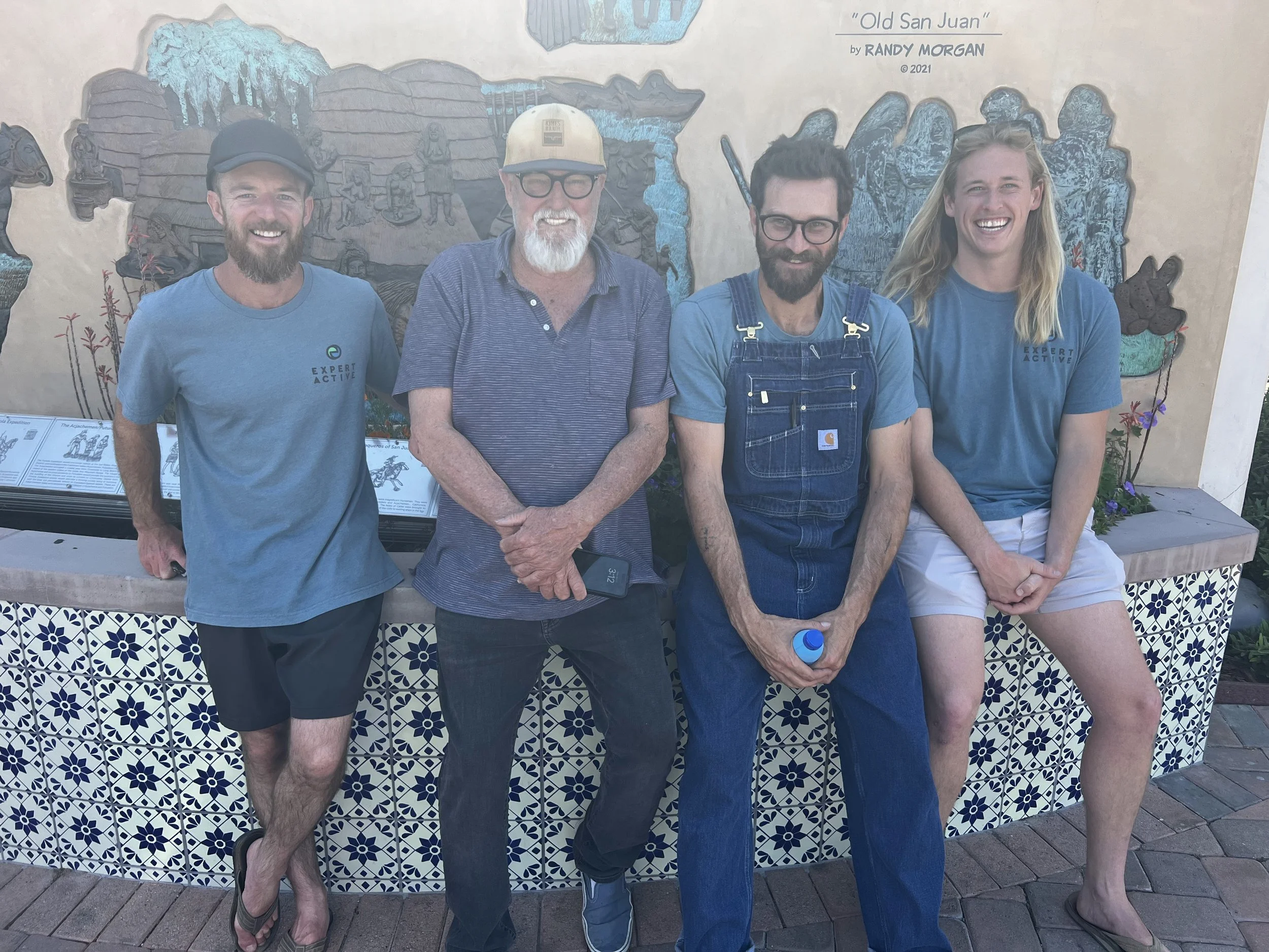 Foodie tour guests by a mural and tile bench in San Juan Capistrano