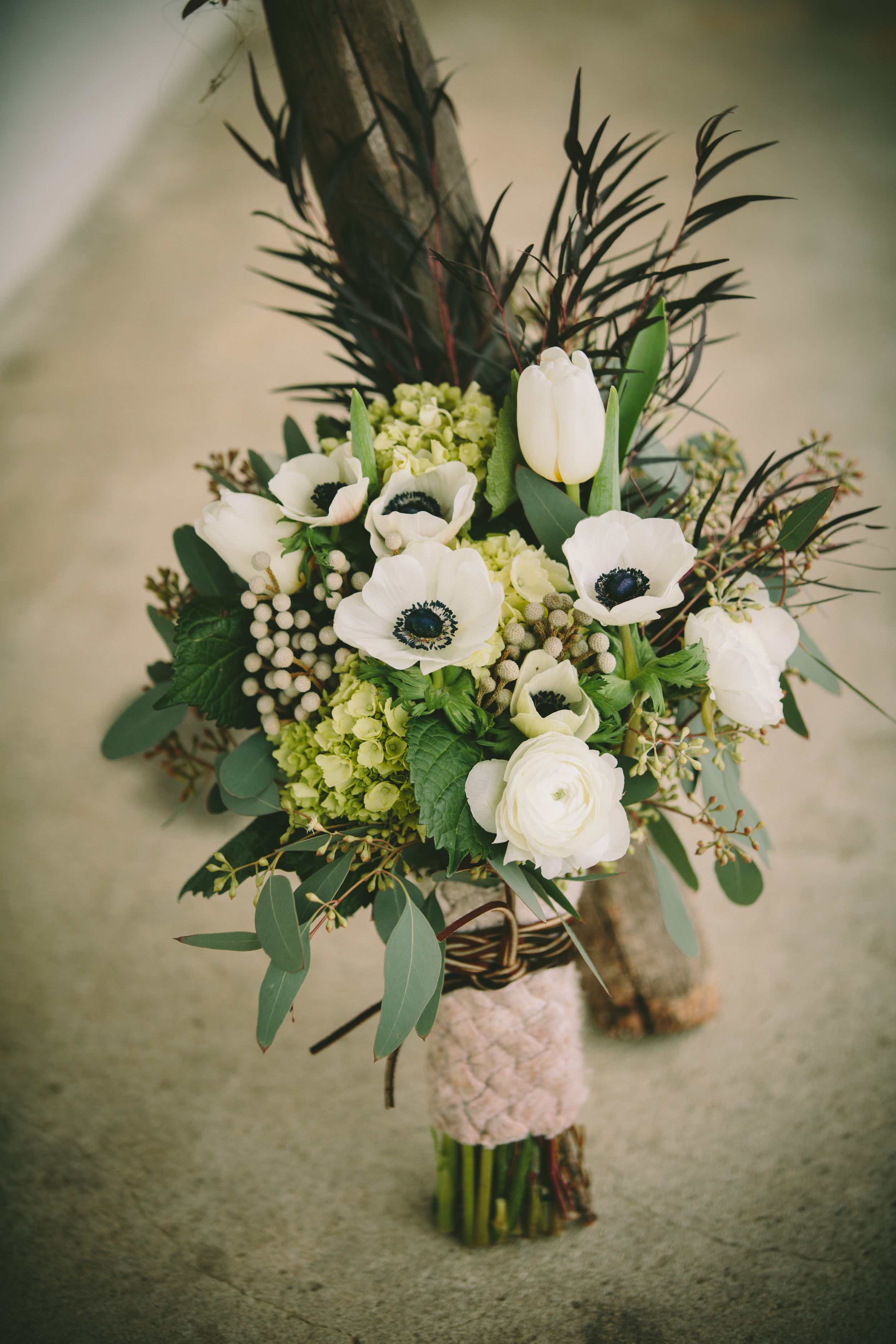  Bouquet wrapped in a vintage cable knit sweater tied with leather cord. 