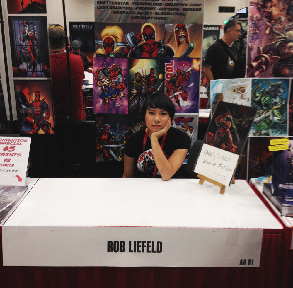 Kristina working as a seat warmer for Rob Liefeld 