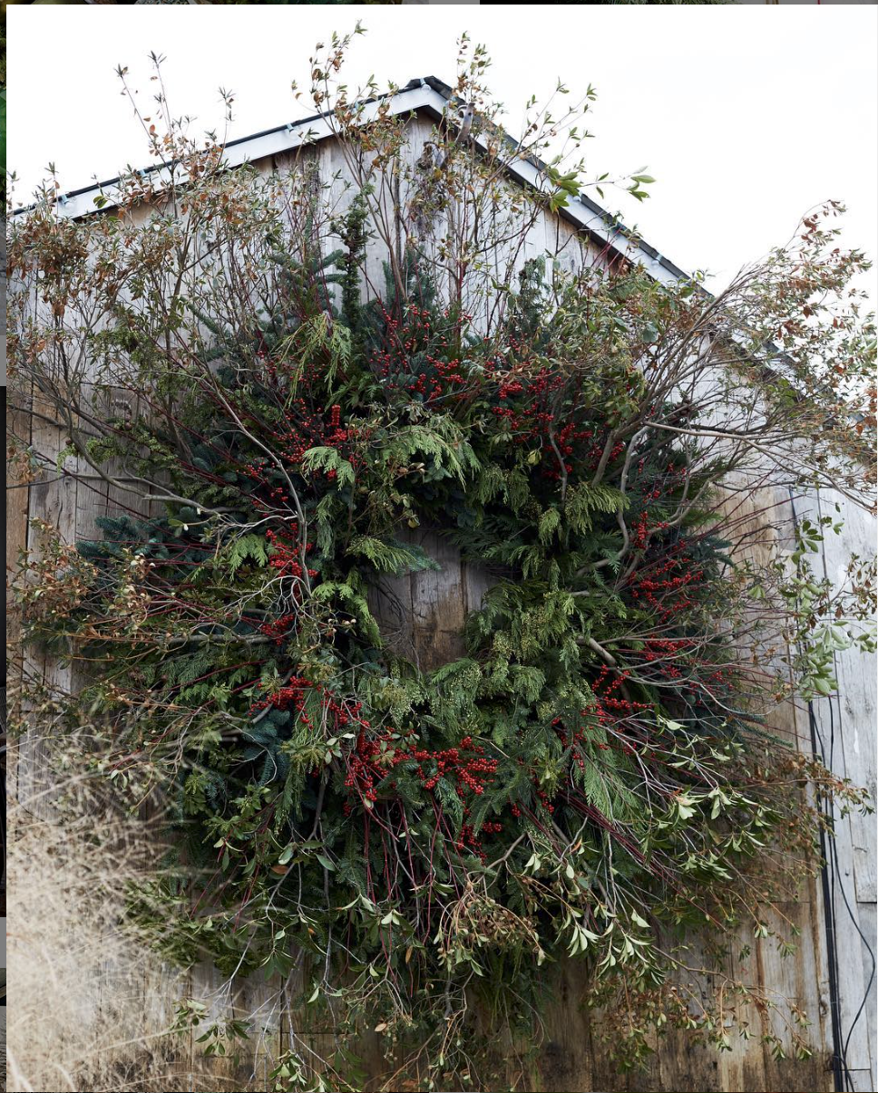  Over sized wreath created with tree limbs, evergreen, and ilex berries for Terrain, featured in the Terrain: Ideas and Inspiration for Decorating the Home and Garden book. 2017. 