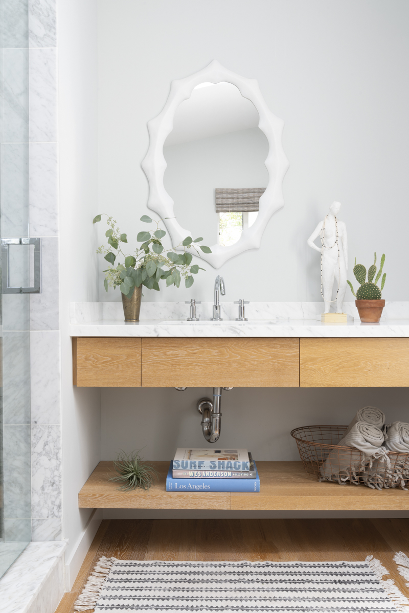  This master bath was so much fun to design. I usually switch up the decor each season with new books, towels, and accessories.  Photo by Annie Meisel.  