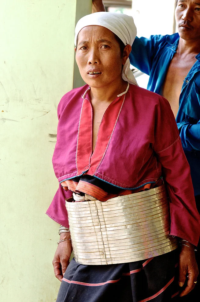 The women of the Jzin-uh Palaung are distinguishable by their thick silver-plated belts and white headscarves. Though all Palaung live high up in the Shan mountains, each of the tribes has a distinct dialect and traditional form of dress.