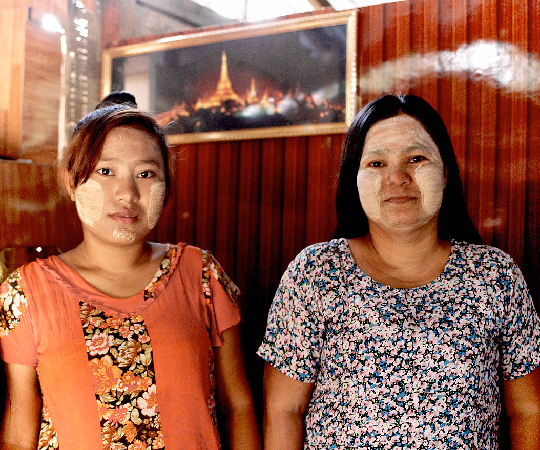 Ai Mon stands here with her mother, Aye Aye, in their living room. As devout Buddhists, they decorate their home with many holy images including the one behind them of Shwedagon Pagoda —the largest and holiest Buddhist monument in Myanmar.