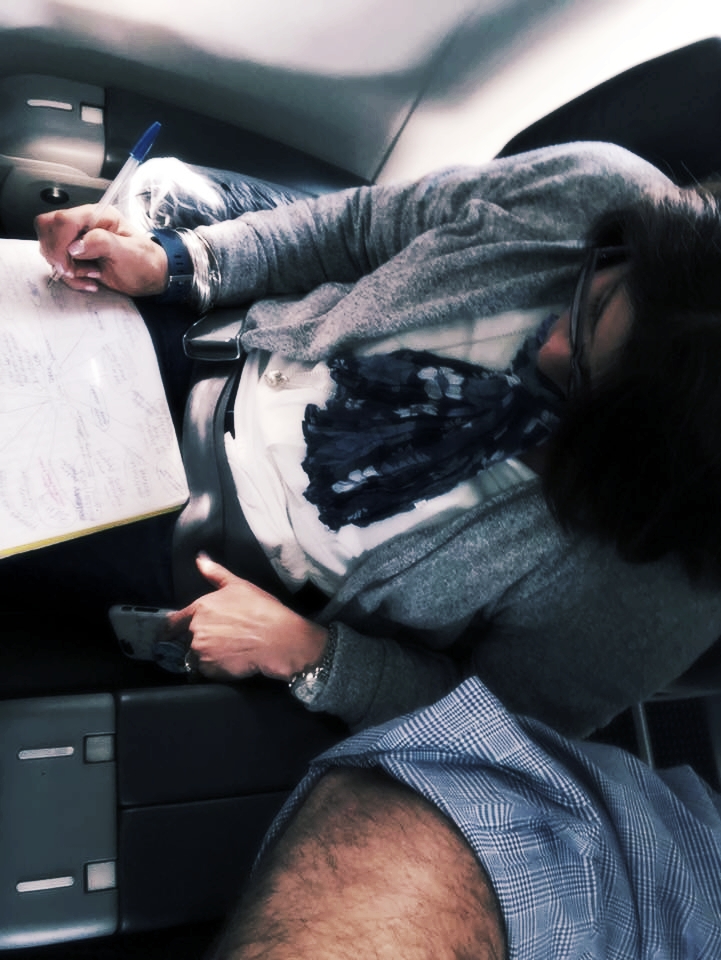allison writing on a plane.jpg