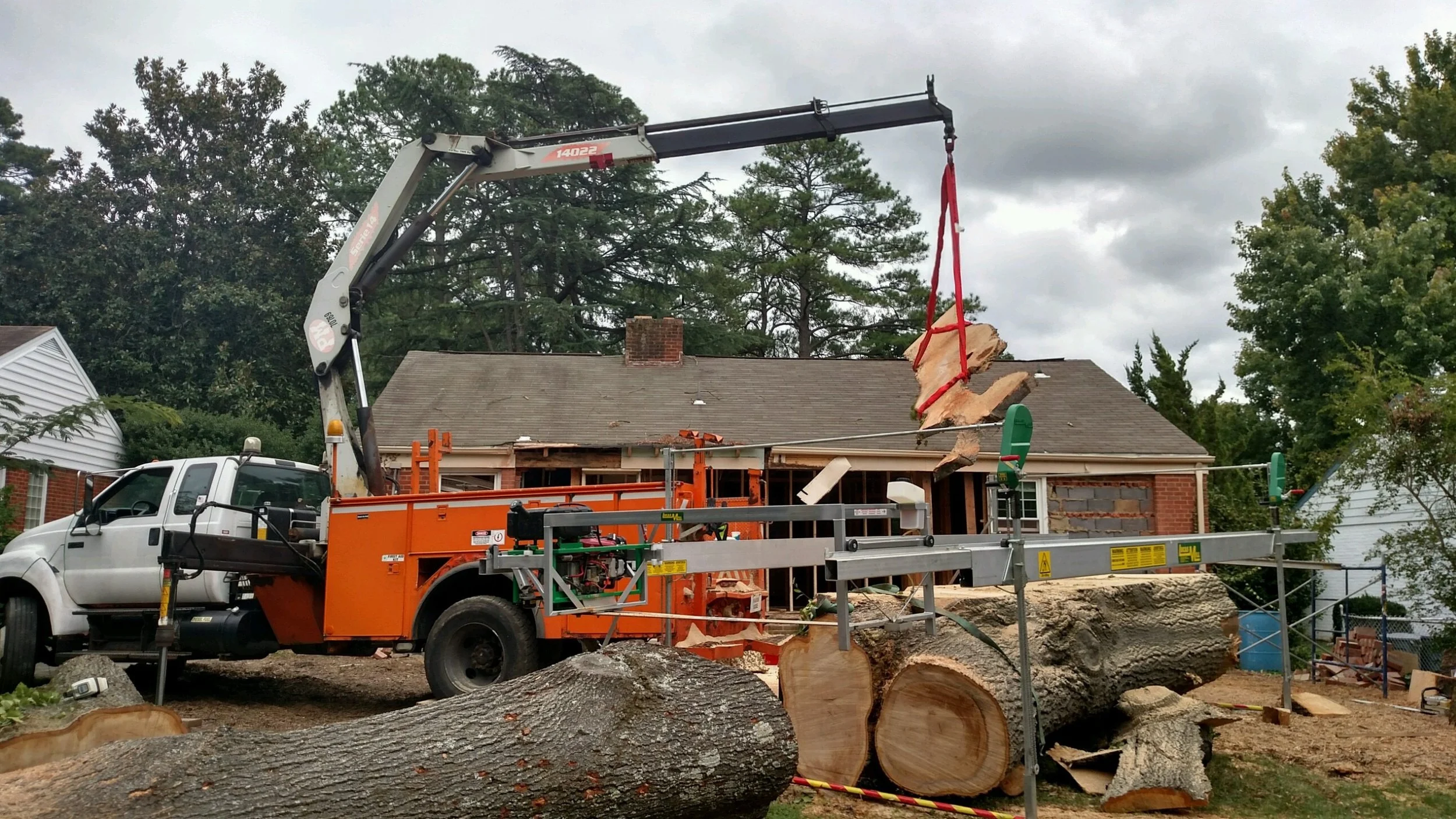 Using the crane to pull each slab off the log