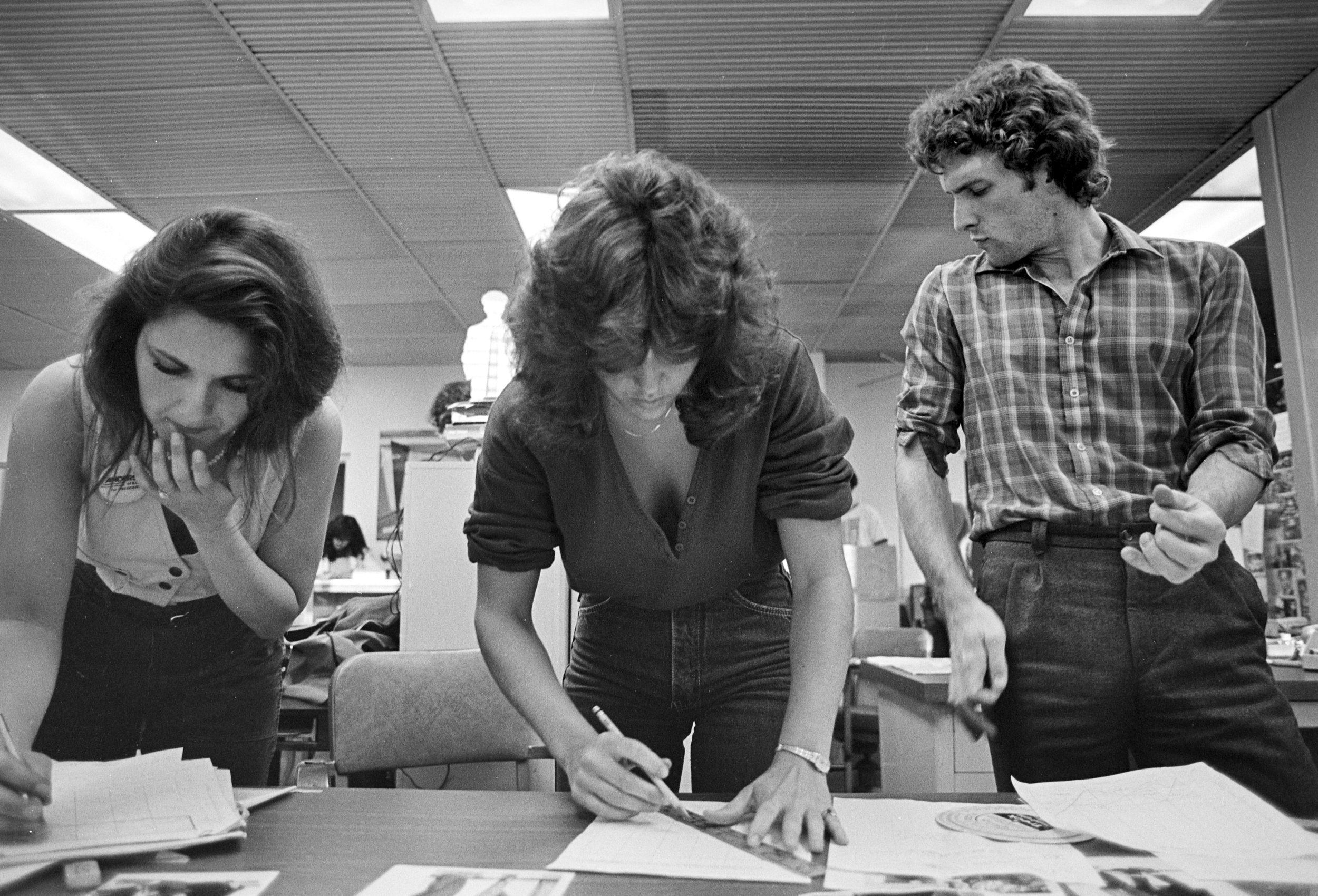 Tina Susman and Donna Pomerantz work on final production deadline as Bill Harris cranks out his own rift.