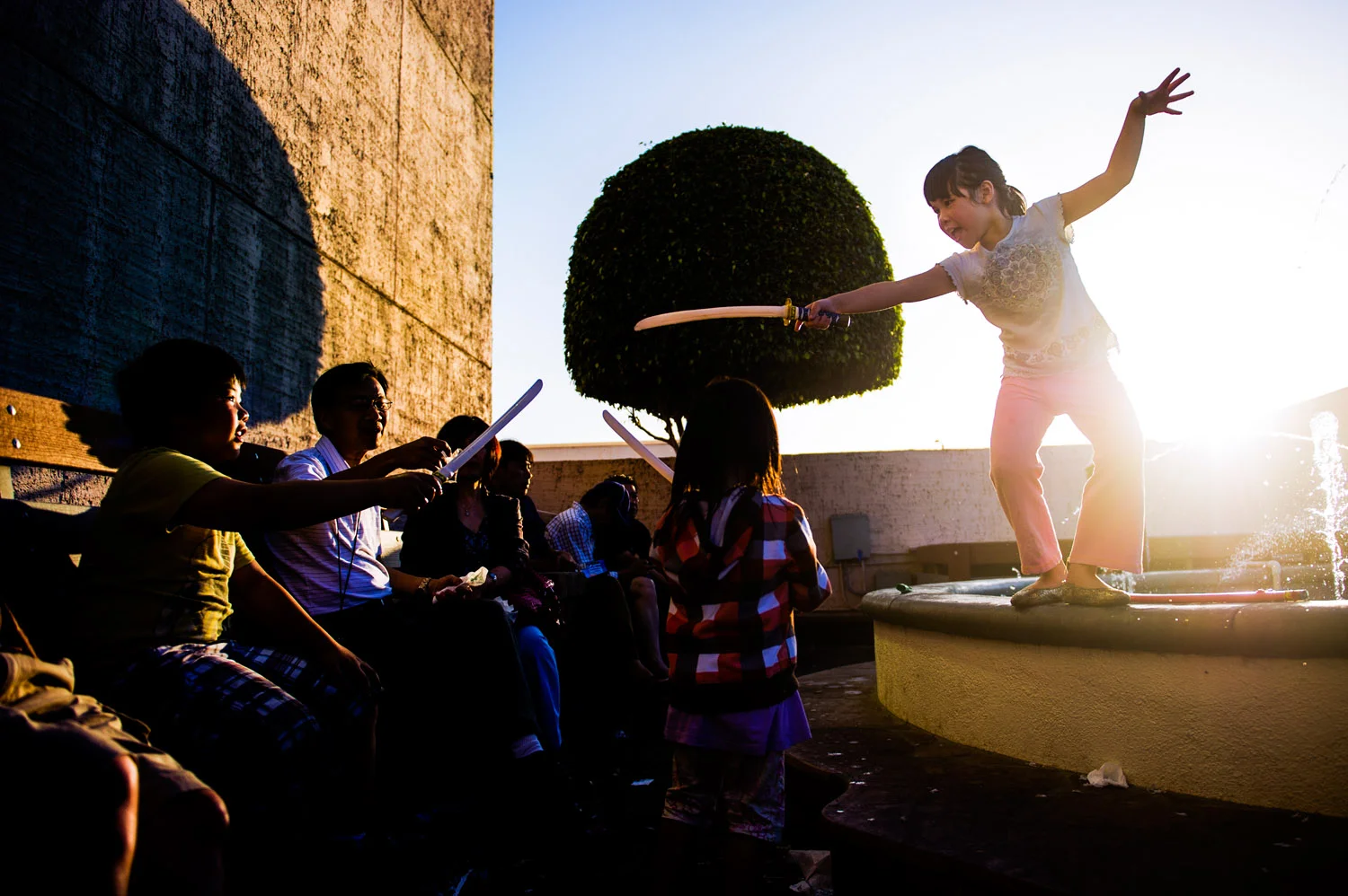 Girl plays on fountain in Little Saigon