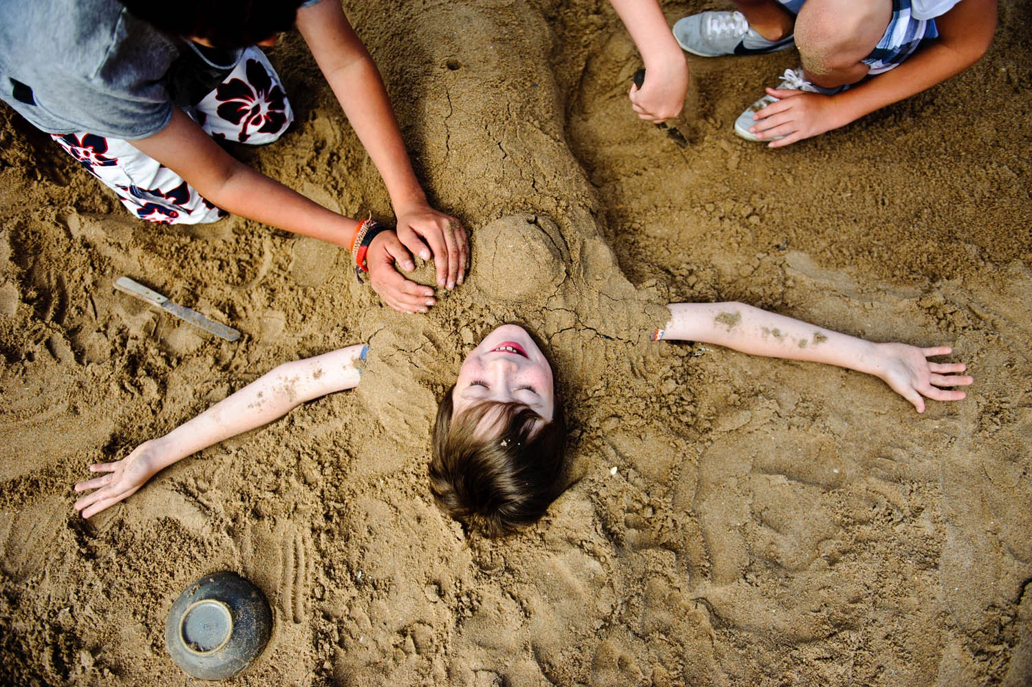 Boy is buried in sand